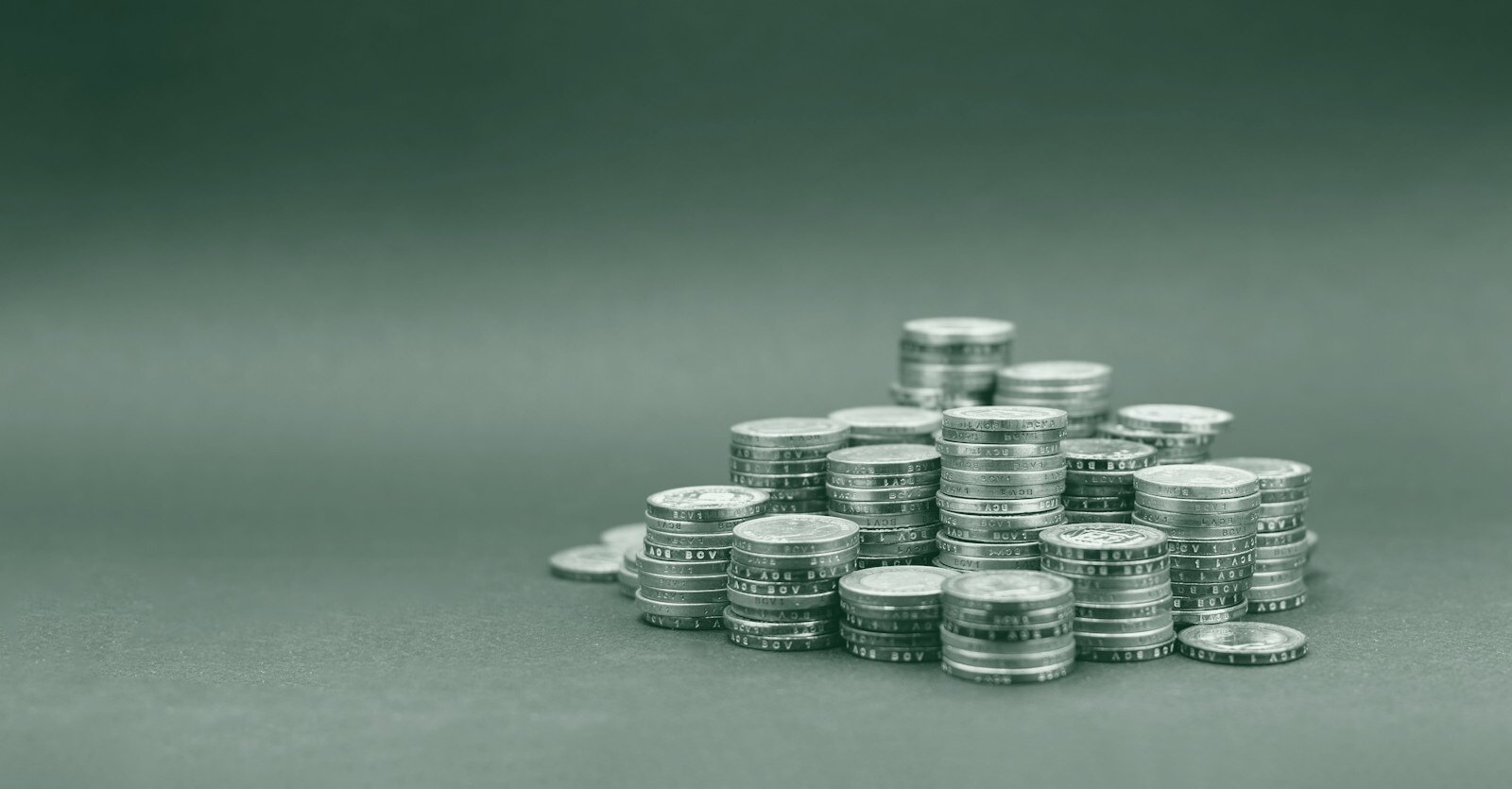 A pile of gold coins on a dark background
