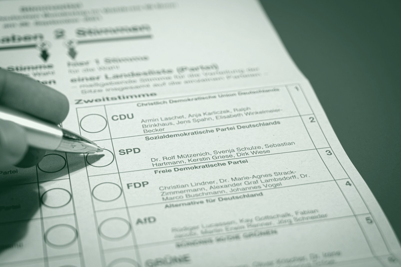 a person is filling out a form with a pen