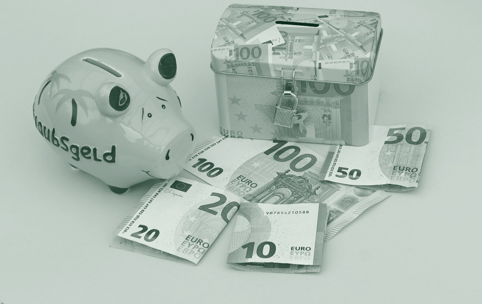 A yellow piggy bank and a locked metal box with euro banknotes on yellow